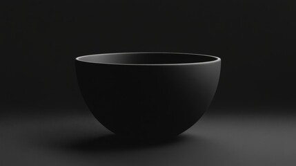 Minimalistic black bowl on a dark surface, showcasing elegant design in a serene setting