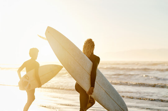 Sunset, surfboard and men running to waves on beach together in evening on surf holiday in Hawaii. Surfer friends, fun hobby and freedom in water on surfing vacation adventure with ocean mockup.