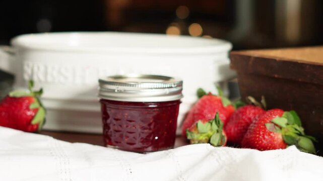 Cooking strawberry jam and canning them for food storage and for gifts.  strawberry jam made with fresh strawberries and sugar and easy recipe.
