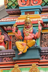 Vishnu's Nrisimha avatar on a colorful dome of a Hindu temple in Tamil or Dravidian style.