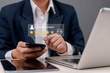 A businessman using a smartphone to check customer reviews and ratings. Online feedback, reputation management, and digital marketing concept for business growth.