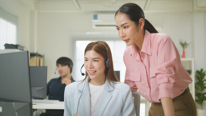 Fototapeta premium Learning, computer and training business interns in modern office. Customer service job, Cheerful asian business woman discussing project results with colleagues working together, software developers