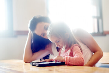 Mother, daughter and learning with tablet in home for online education, watching cartoon or child...