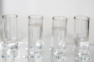 Clear bottles and dishes are used in scientific and medical experiments.