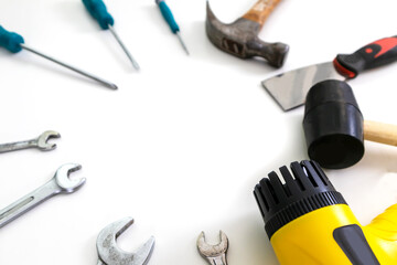 Set of tools and equipment, screwdrivers of various sizes, hammer and blower on white background.