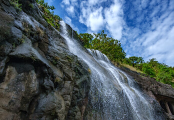 A waterfall during the monsoons near Pune India. Monsoon is the annual rainy season in India from...