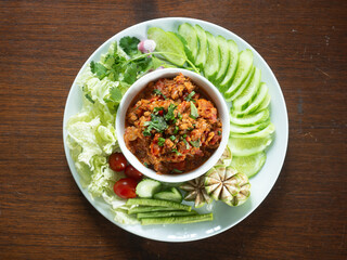 top view of NAM PRIK ONG - Spicy Thai Northern pork and tomato chili dip, served with mix fresh vegetables