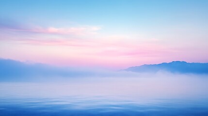 Serene Misty Mountainscape at Dawn Over Calm Water