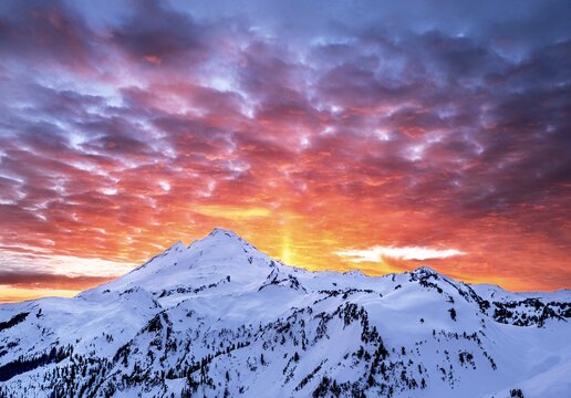 Ghost asperitas clouds over the mountains covered with glacier and snow at sunset. Mt Baker Ski Resort. WA. USA