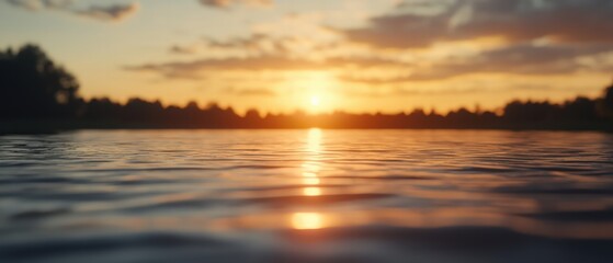 Obraz premium Serene Sunset Over Calm Water Surface with Reflections and Silhouette of Trees in Background
