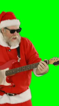 Santa claus singing a song and playing guitar