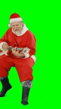 Santa claus singing a song and playing guitar