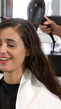 Pretty woman getting her hair dried