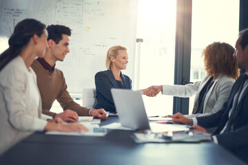 Office, meeting and business people with handshake for success, sales partnership and b2b agreement. Flare, employee and investor with shaking hands for company growth, investment deal and laptop