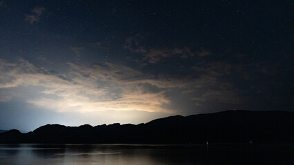 early morning galaxy visible during early morning with stars above Okanagan lake