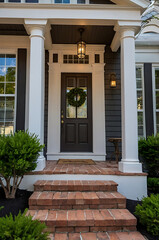 Elegant Home Exterior with Classic Porch and Brick Steps. Beautiful front door design with a welcoming entrance. Perfect for real estate listings and architectural inspiration.