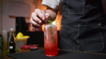 Bartender crafting a cocktail in a cozy bar. Perfect for restaurant promos or bartending tutorials.