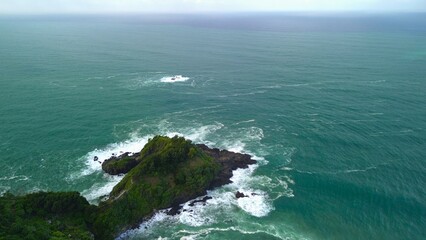 Bird eye view View of the coastline with hills and trees, cliffs, coral reefs and waves from the sea at Surumanis Beach, Kebumen, Central Java