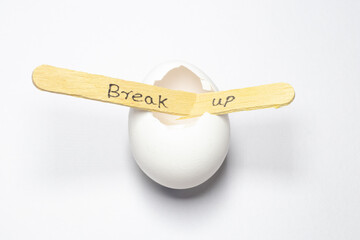 close up of a hand written message on a popsicle stick stating a break up, a love failure mood