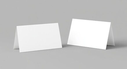 Two blank white folded greeting cards mockup on gray background.
