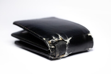 Old black wallet on white background. worn out leather wallet. Selective focus