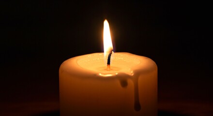 burning candle in the dark