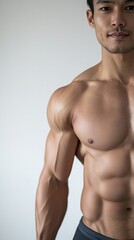 Fototapeta premium Portrait of a Muscular Man with Defined Chest and Strong Arms inStudio Setting