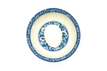 A decorative ceramic plate with a blue and white floral pattern, perfect for adding a touch of elegance to any table setting