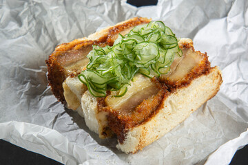 Katsu sando, Classic sandwich from Japanese bars, combines pork fillet breaded in panko flour, pickles, Japanese karashi mustard, Kewpie mayonnaise