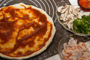 Preparing seafood homemade pizza. close up.