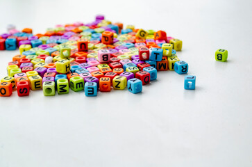 Colorful plastic alphabet beads with letters printed on them