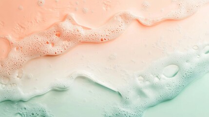 Obraz premium Close up abstract photo of creamy foam on a pastel green and orange background. The white bubbles are a perfect abstract shape and pattern, and the colors give a soft and gentle feel. 