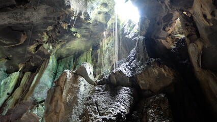 A cave with light shining through.