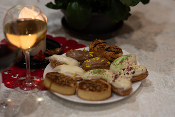 white burning candle and glass of wine, holiday celebration, table decoration