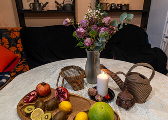 still life with white candle, dry flowers, fruits and other objects