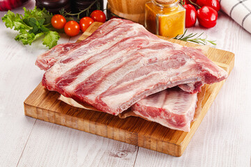 Raw pork ribs over board