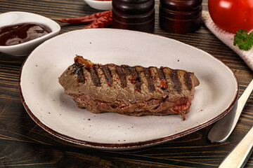 Grilled beef striploin steak with sauce