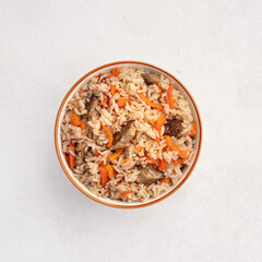 Pilaf, eastern dish of rice, meat, carrots with spices, top view