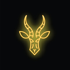 Yellow neon sign representing a gazelle head, with long horns, on a black background