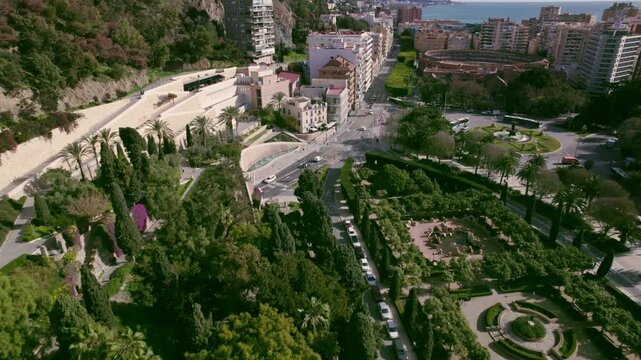 Forward aerial reveal of terrace stairs and roundabout with Bullring Malagueta Plaza de Toros incapsulated in residential area on Sun Coast Mediterranean Malaga