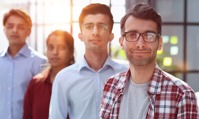 Fototapeta premium a group of business people smiling in the office lined up with a leader guy