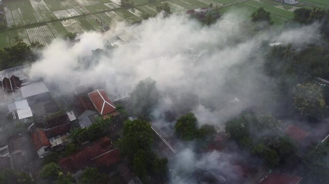 Aerial view of fogging to eliminate mosquito for preventing spread dengue fever and zika virus in residential areas