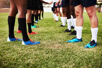 Fototapeta premium Rugby, men or legs on field for game, competition start or group handshake for sportsmanship. Sports team, boots or competitive on grass with respect, tournament or ready for match at outdoor stadium