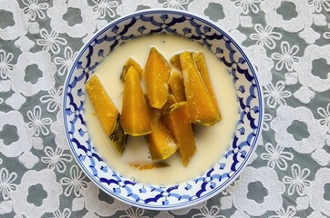 Poached Pumpkin in Coconut Milk, Thai food. Sweet Pumpkin Slices in Creamy Coconut Sauce Dessert Bowl