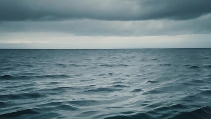Fototapeta premium a large body of water under a cloudy sky