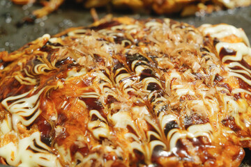 Osaka Japan regional specialty dish Okonomiyaki on grill