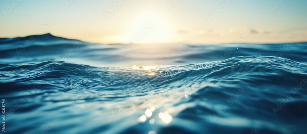 Poster Sunset over calm ocean waves with reflective surface and soft light creating a tranquil atmosphere copy space