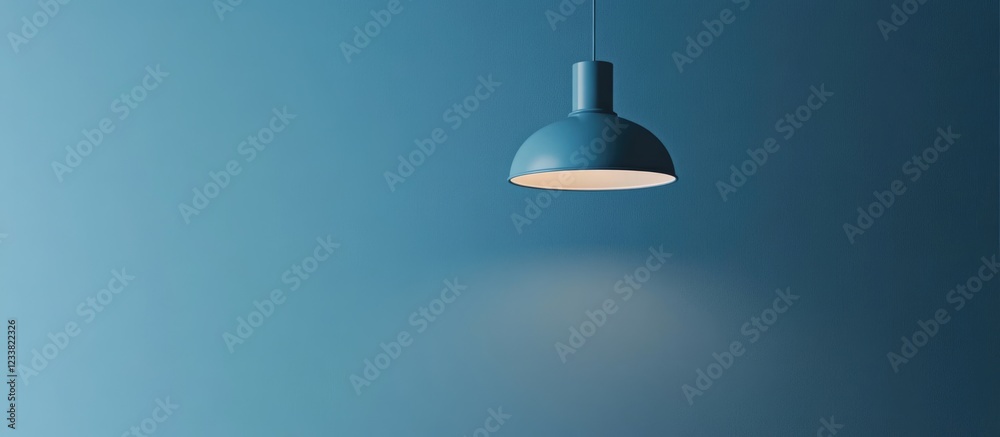 Poster blue pendant lamp hanging from ceiling with soft light on textured wall copy space