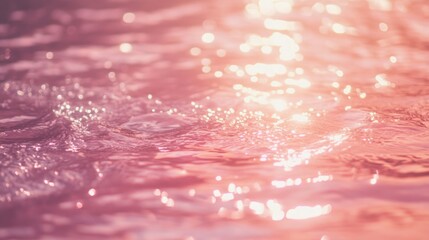 Soft pink water surface with shimmering reflections and gentle ripples under bright light. Copy Space available.