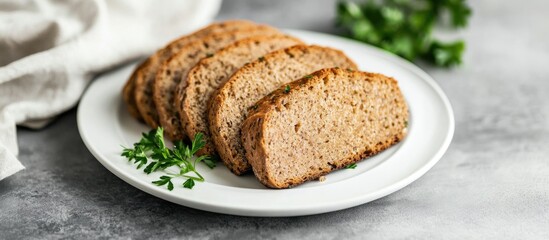Naklejka premium Sliced homemade bread on a white plate garnished with fresh herbs on a gray stone background Copy Space